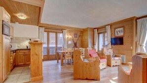 A wooden cabin interior with a kitchen, dining area, and seating. - Ground floor, balcony, parking, tv, ski locker, 68m², Morzine (Morzine)