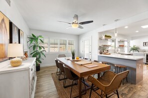 Enjoy meals in the spacious kitchen and dining area, featuring a central island, oven, and comfortable seating for all.