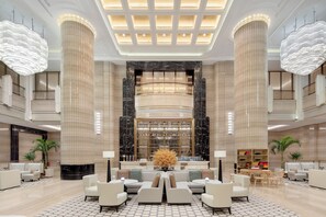 A spacious lobby with high ceilings, large columns, and a central seating area. - Crowne Plaza Chengdu Tianfu New Area by IHG (Chengdu)