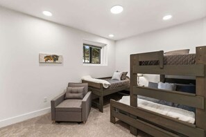 A bedroom with bunk beds, a sofa, and a small window. - Ski-in/Ski-Out Slopeside Luxury Condo in Big Sky (Big Sky)
