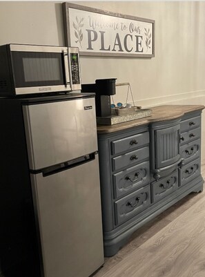 Fridge, microwave, coffee/tea maker, cookware/dishes/utensils