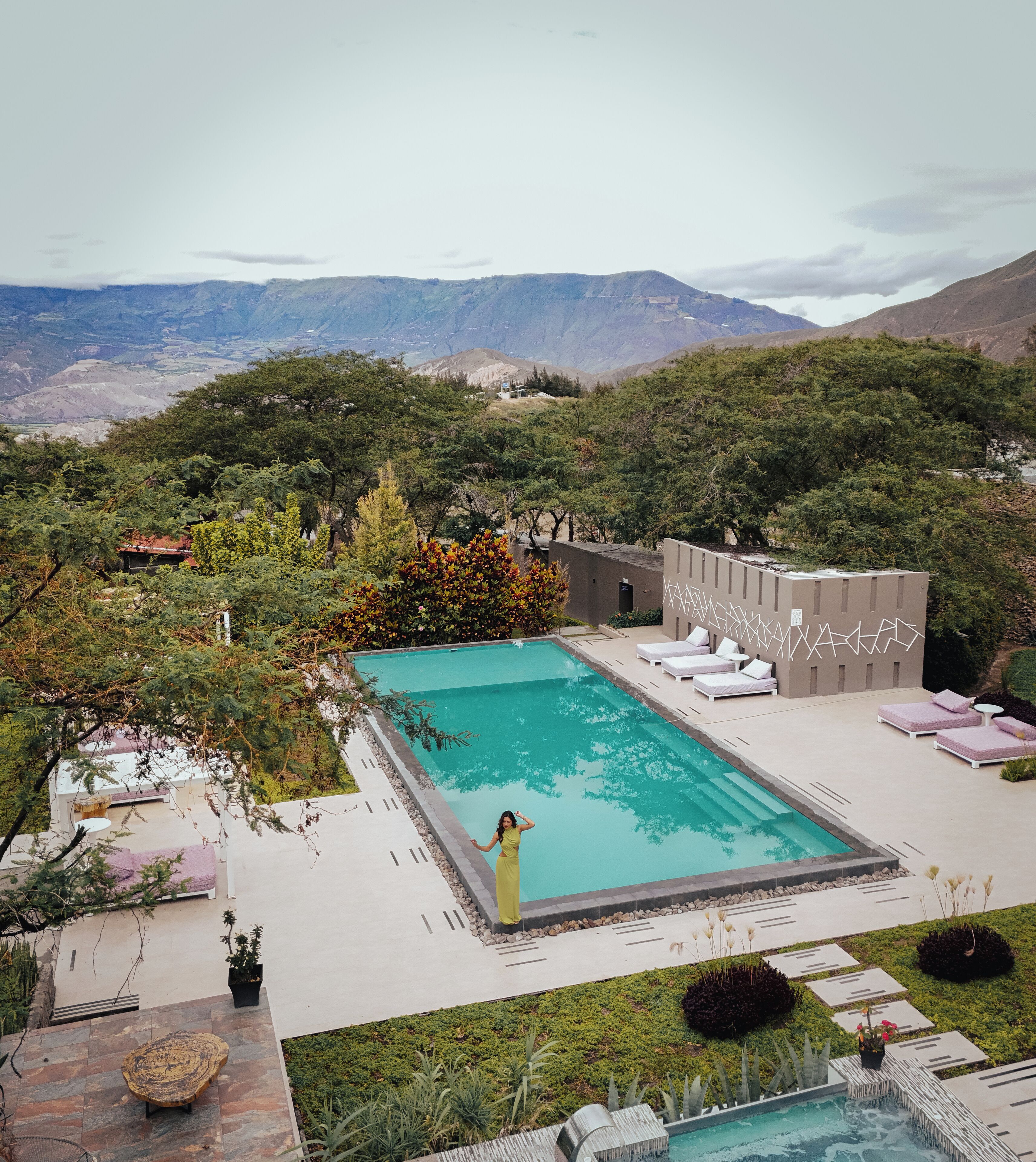 Ein Poolbereich mit Liegestühlen und Blick auf die Berge.