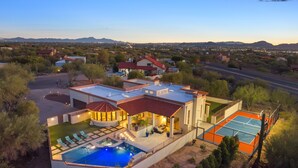 A modern house with a swimming pool, tennis court, and a patio area. - Fun-for-all! Pool! Private Pickleball Court! Game room! (Tucson)