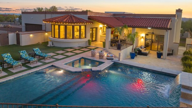 A swimming pool with lounge chairs, a covered seating area, and a patio with potted plants. - Fun-for-all! Pool! Private Pickleball Court! Game room! (Tucson)