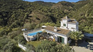 A villa with a swimming pool, surrounded by lush greenery and hills. - Charming Rural Retreat, A/C, Private Pool & Beautiful Views - 11km from the Coastal Town of Tavira! (Tavira)