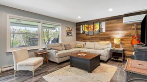 A living room with a sofa, armchair, coffee table, and a fireplace. - Stratton; 8 min! Fire Pit. BBQ. Pet friendly (Winhall)