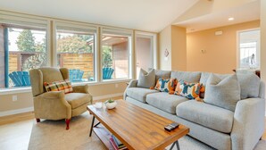 A living room with a sofa, armchair, and coffee table. - Near Eats & Brews! Beautiful Seattle Home w/ Patio (Seattle)