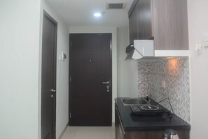 Studio | Private kitchen | Full-sized fridge, stovetop - Homey And Minimalist Studio Grand Dhika City Apartment (Bekasi)