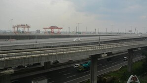 A multi-level highway with vehicles, overpasses, and industrial structures.