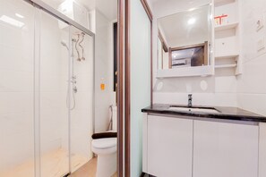 Enjoy a clean and contemporary bathroom with a glass-enclosed shower, handheld showerhead, and separate toilet with bidet.