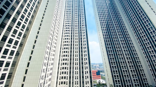 A view of tall, modern buildings with a clear sky. - Homey And Cozy Stay Studio Room Pollux Chadstone Apartment (Cikarang)