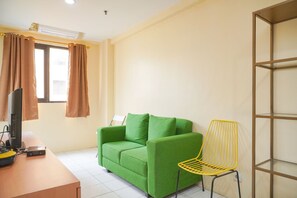 Relax in this cozy space with a sofa, chair, and flat-screen TV.