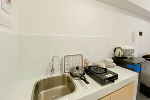 Studio | Private kitchen | Full-sized fridge, stovetop - Homey And New Studio At Tokyo Riverside Pik 2 Apartment (Teluknaga)