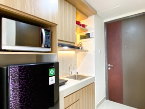 Studio | Private kitchen | Full-sized fridge, stovetop - Cozy And Homey Studio Room Pollux Chadstone Apartment (Cikarang)