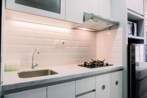 Private kitchen - Restful And Well Furnished Studio Transpark Bintaro Apartment (South Tangerang)