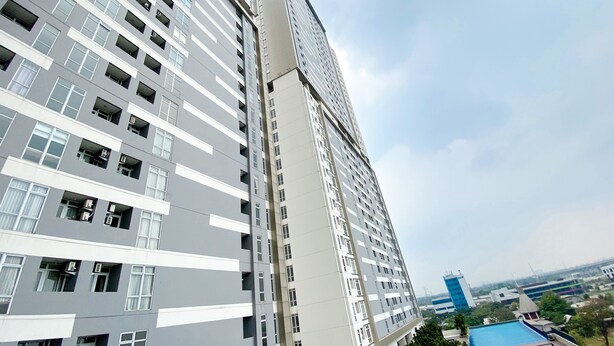A high-rise building with multiple floors, large windows, and balconies. - Great Deal And Pleasurable 2Br Vasanta Innopark Apartment (Cikarang)