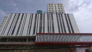 A building with a modern design, featuring vertical stripes and a prominent logo at the top.