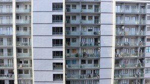 A high-rise building with multiple balconies, each with glass railings and air conditioning units. - Spacious And Homey Studio At Daan Mogot City Apartment (Jakarta)
