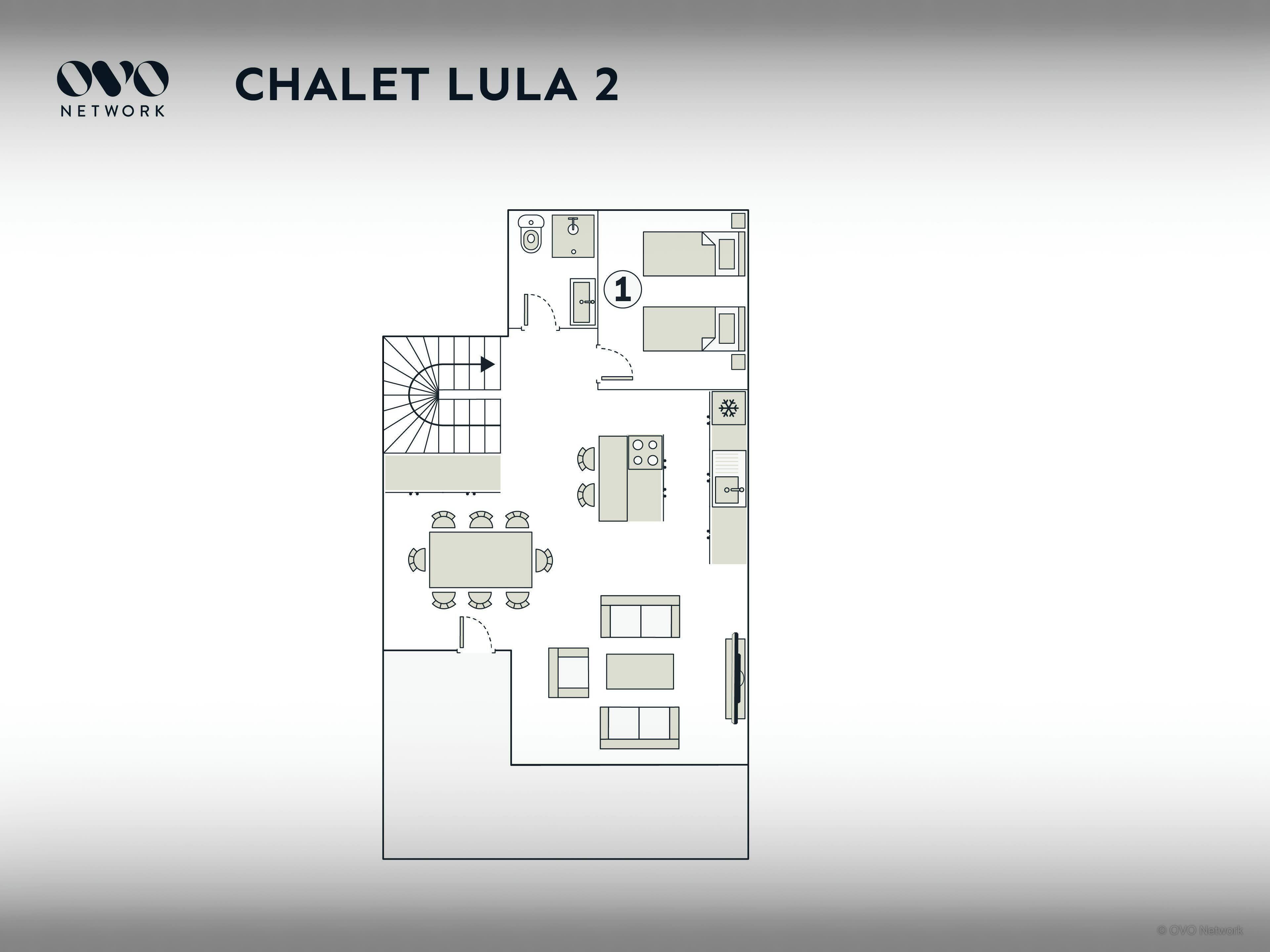 Plan d’étage du chalet Lula 2, comprenant une cuisine, un coin repas et un escalier.