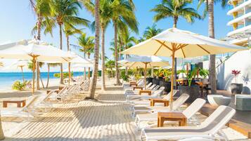 On the beach, white sand, beach umbrellas, beach towels