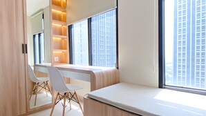 A modern room with a large window, a white desk, and a chair. - Comfort Stay Studio Room Pollux Chadstone Apartment (Cikarang)