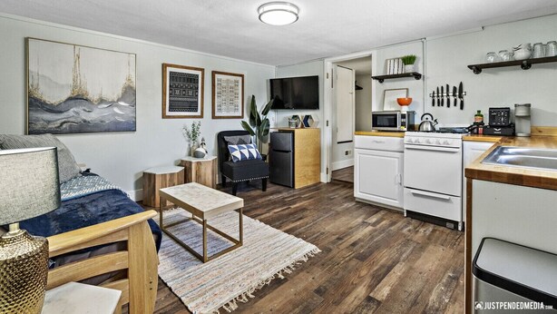 A compact living space with a kitchenette, a dining area, and a seating area. - Walking distance to restaurants, trails, and cafes.  10 min. uber from airport. (Anchorage)