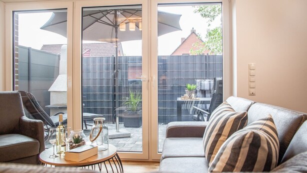 A living room with a sliding glass door leading to a patio area.