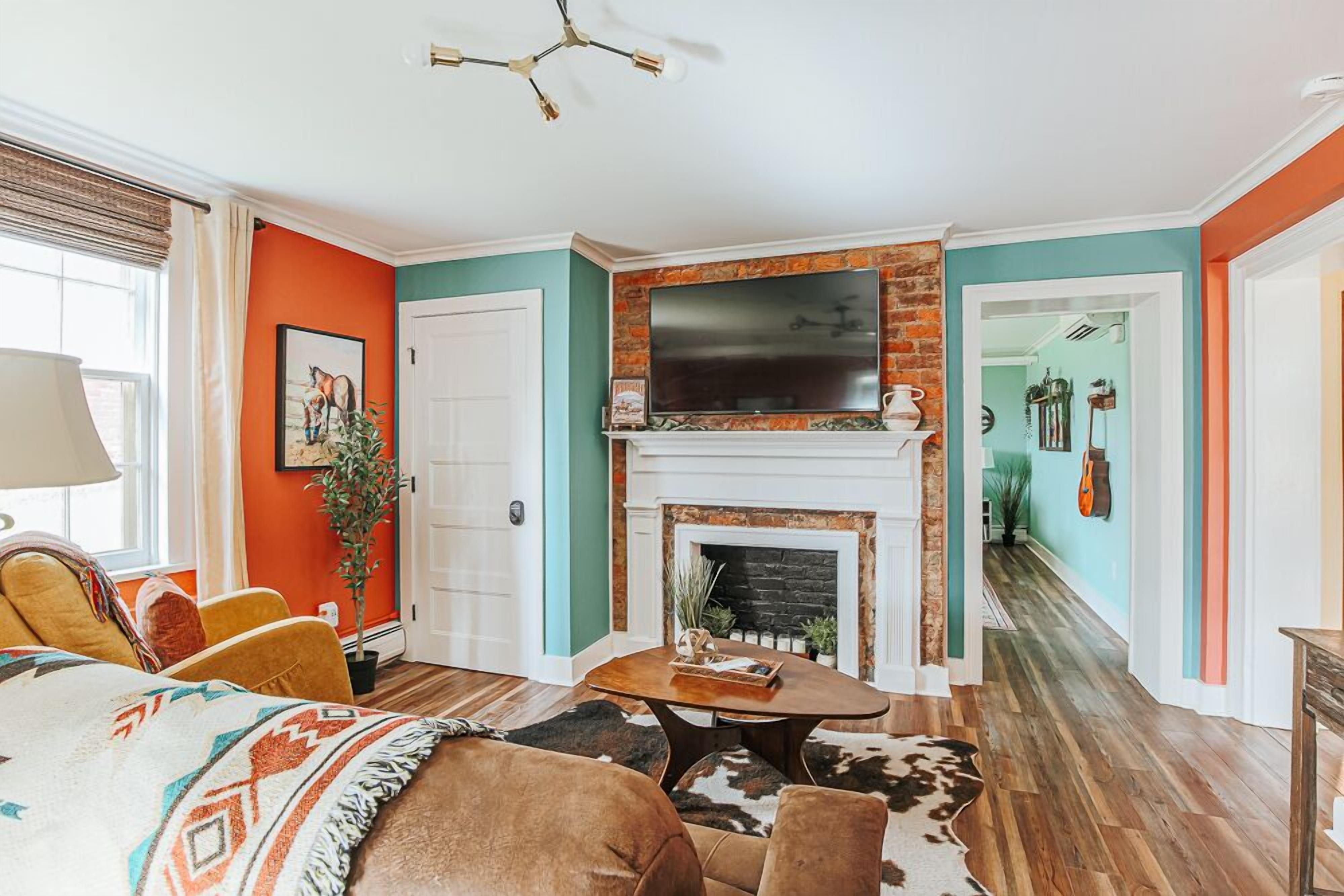 A living room with a fireplace, a television, and a sofa.
