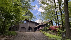 A two-story building with a driveway leading to the entrance. - Family Home with Fire Pit, Games & Pool Access (Somerset)