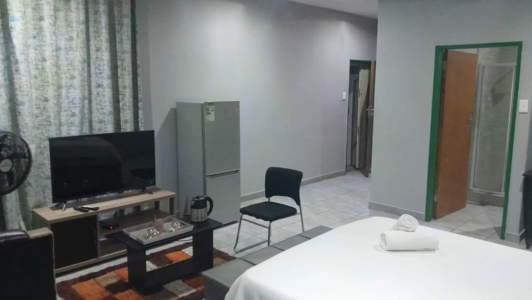 Desk, laptop workspace, iron/ironing board, bed sheets