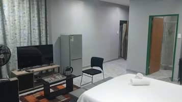 Desk, laptop workspace, iron/ironing board, bed sheets