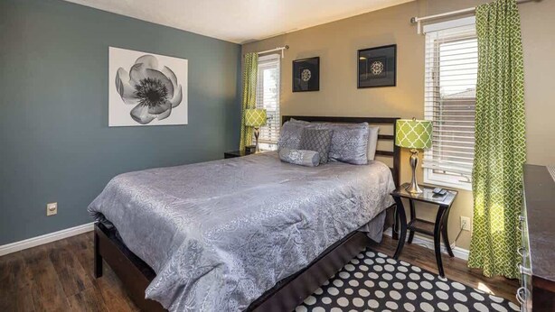 A bedroom with a bed, a nightstand, a lamp, and a window with curtains. - Sports Village Resort #Z9 | Affordable Getaway (Saint George)