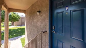A blue door with a number 9 sign, a concrete wall, and a small light fixture. - Sports Village Resort #Z9 | Affordable Getaway (Saint George)