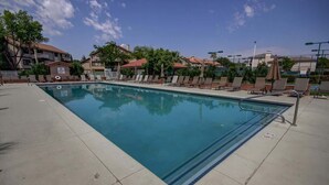 A swimming pool with lounge chairs and a clear sky. - Sports Village Resort #Z9 | Affordable Getaway (Saint George)