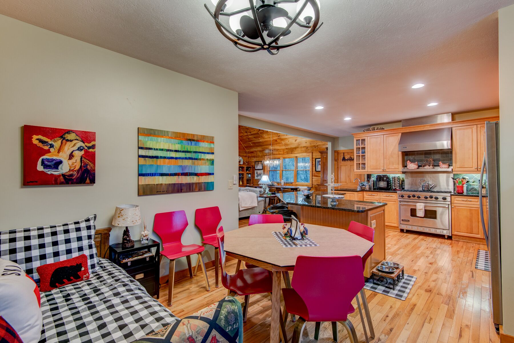 A modern kitchen with wooden cabinets, a stainless steel range hood, and a built-in oven.