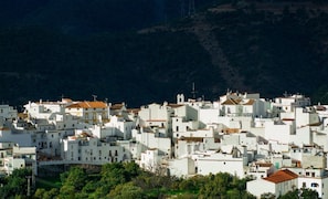 A densely packed town with white buildings and red-tiled roofs.