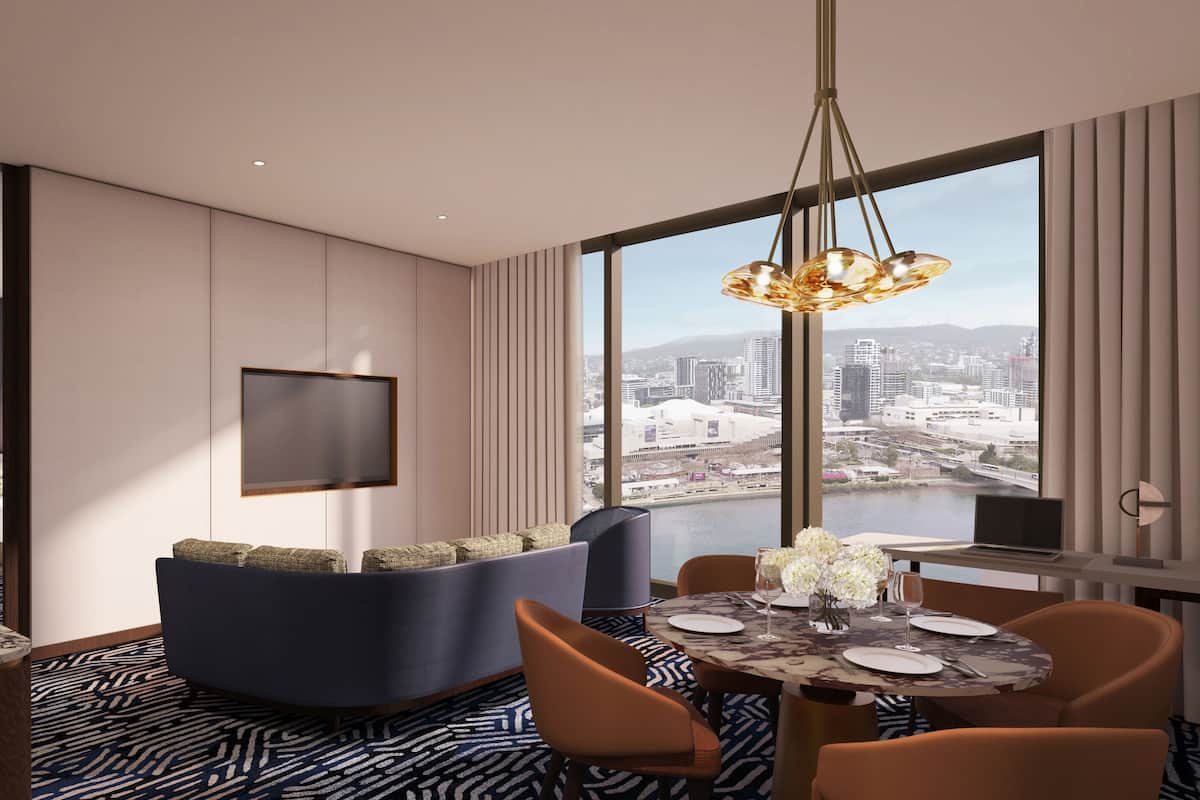 Ein modernes Hotelzimmer mit Blick auf die Stadt, einem Essbereich und einer Sitzecke mit an der Wand montiertem Flachbildfernseher.