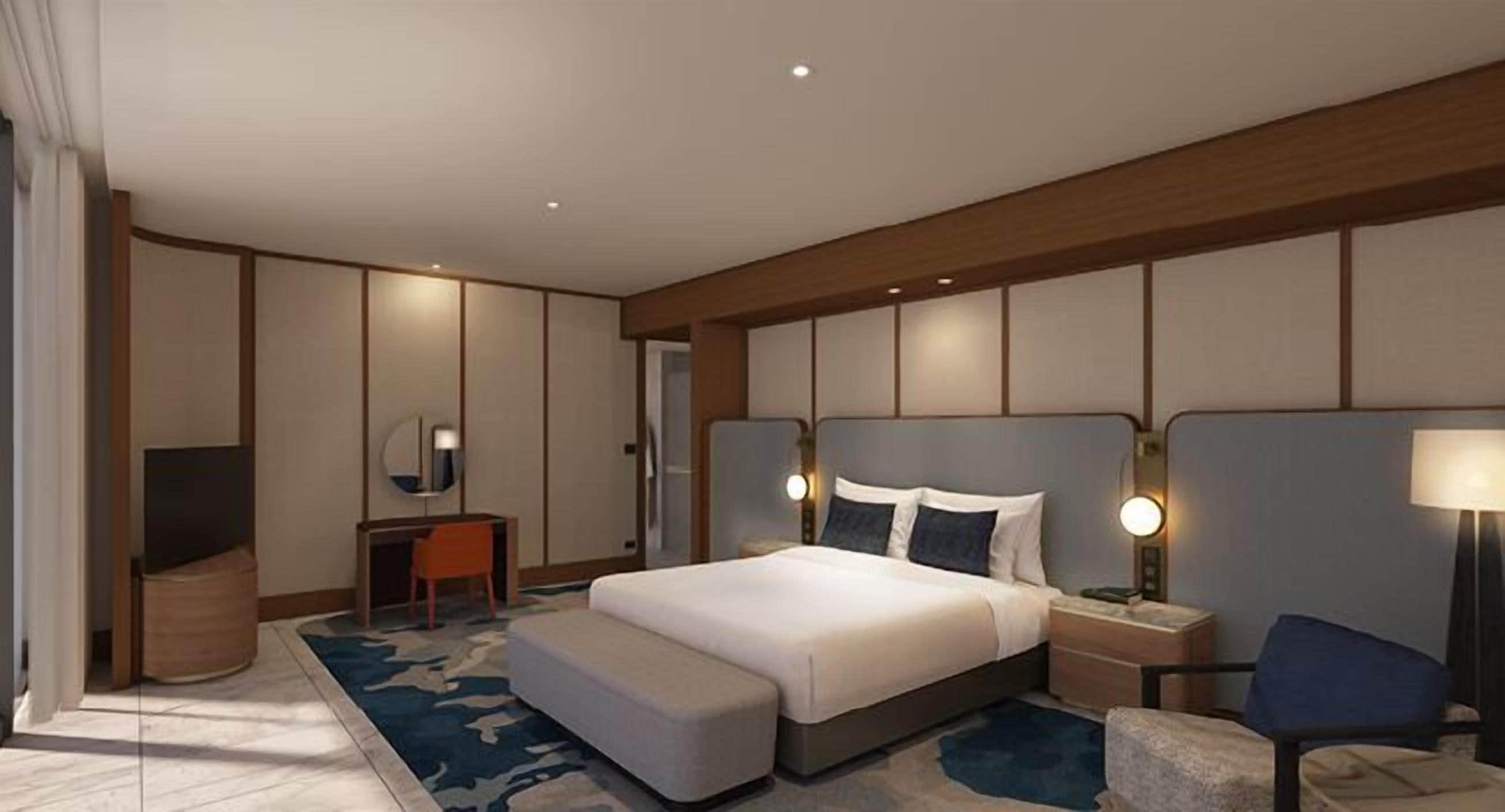 A modern hotel room with a large bed, bedside tables, a desk, and a television.