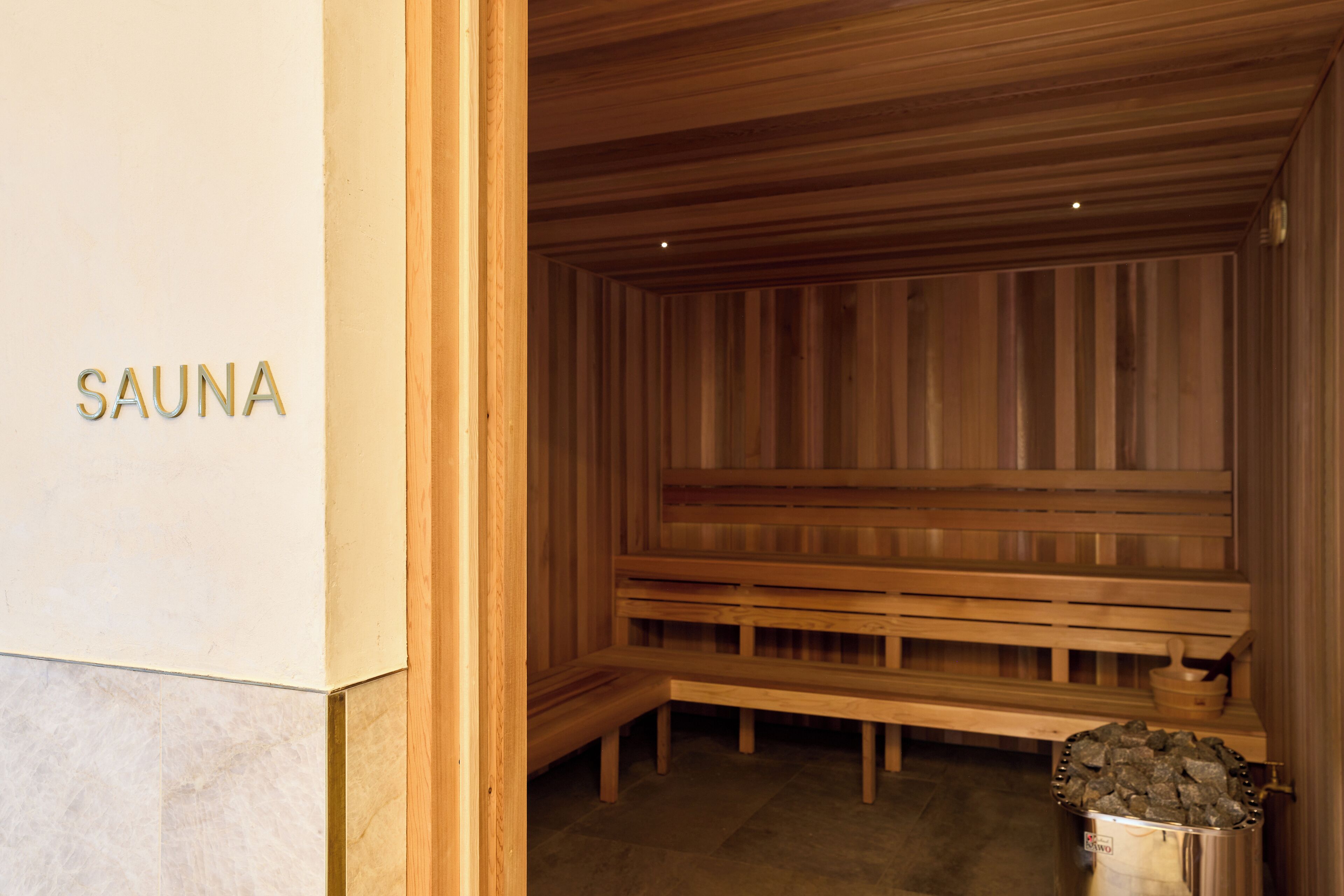 A sauna room with wooden benches and a tiled floor.