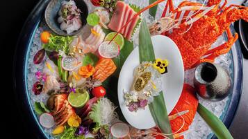 Eine Platte mit Meeresfrüchten, verschiedenen Fischsorten und Beilagen auf einer Eisschicht.