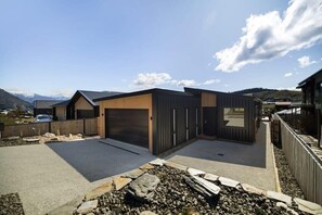 A modern residential area with houses, a driveway, and a clear sky.