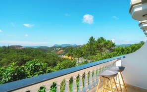 A balcony with a view of a mountainous landscape, white balustrades, and two bar stools. - Dieu Thong Hotel (Xuan Huong - Da Lat)