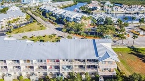 A coastal hotel with multiple balconies, a marina, and a marina view.