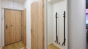 A hallway with wooden doors and a coat rack. - Harrachov 377 by Interhome (Harrachov)