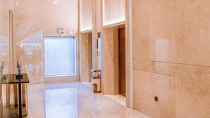 A spacious lobby with a marble floor, a large window, and a reception desk. - LC International Hotel (Yangon)
