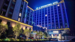 A multi-story hotel with illuminated signage reading "LC INTERNATIONAL HOTEL". - LC International Hotel (Yangon)