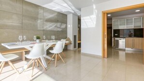 A modern kitchen with stainless steel appliances, a wooden countertop, and a glass door leading to the dining area. - Lizarran by Interhome (Figueres)