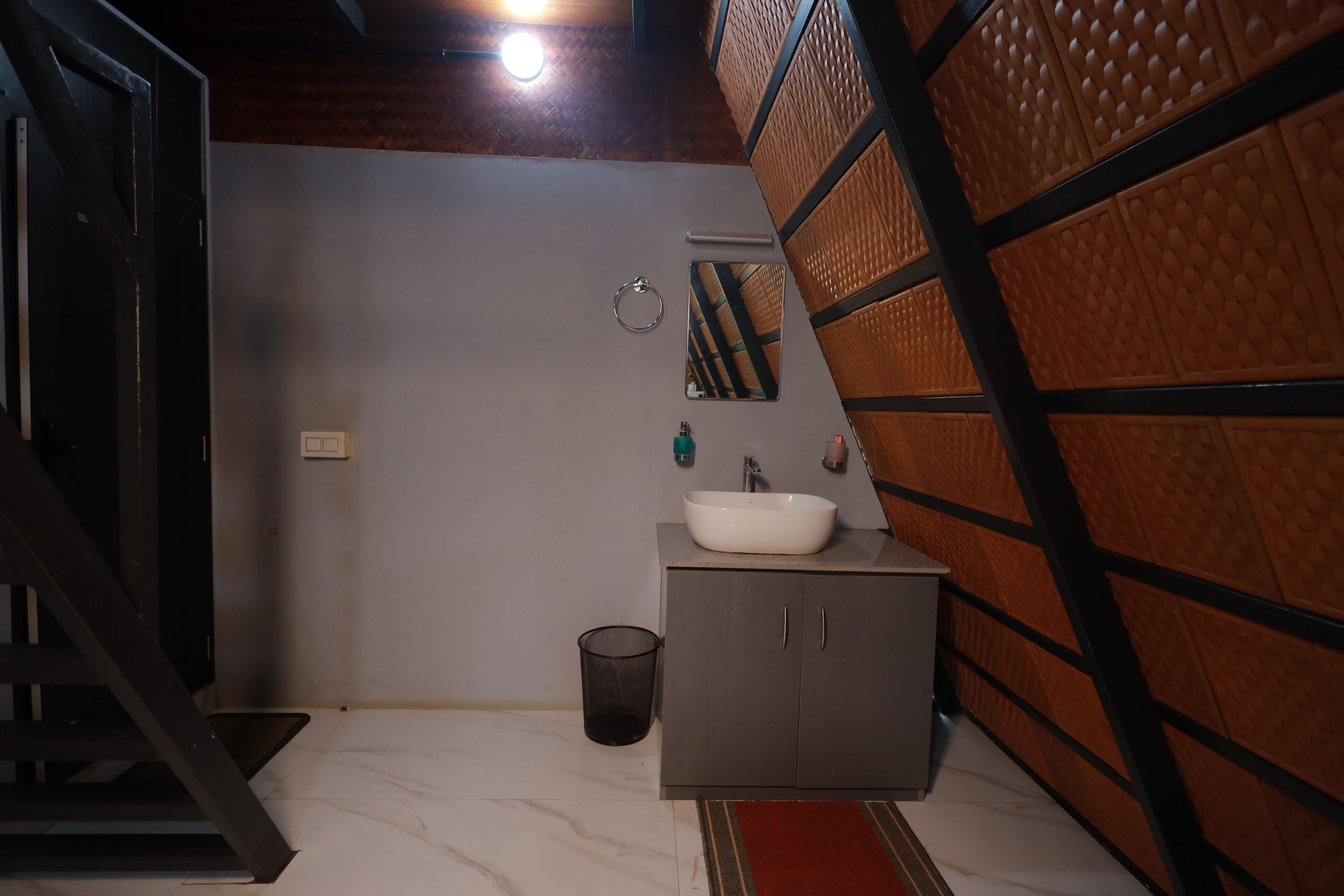 A bathroom with a white sink, a mirror, and a cabinet.