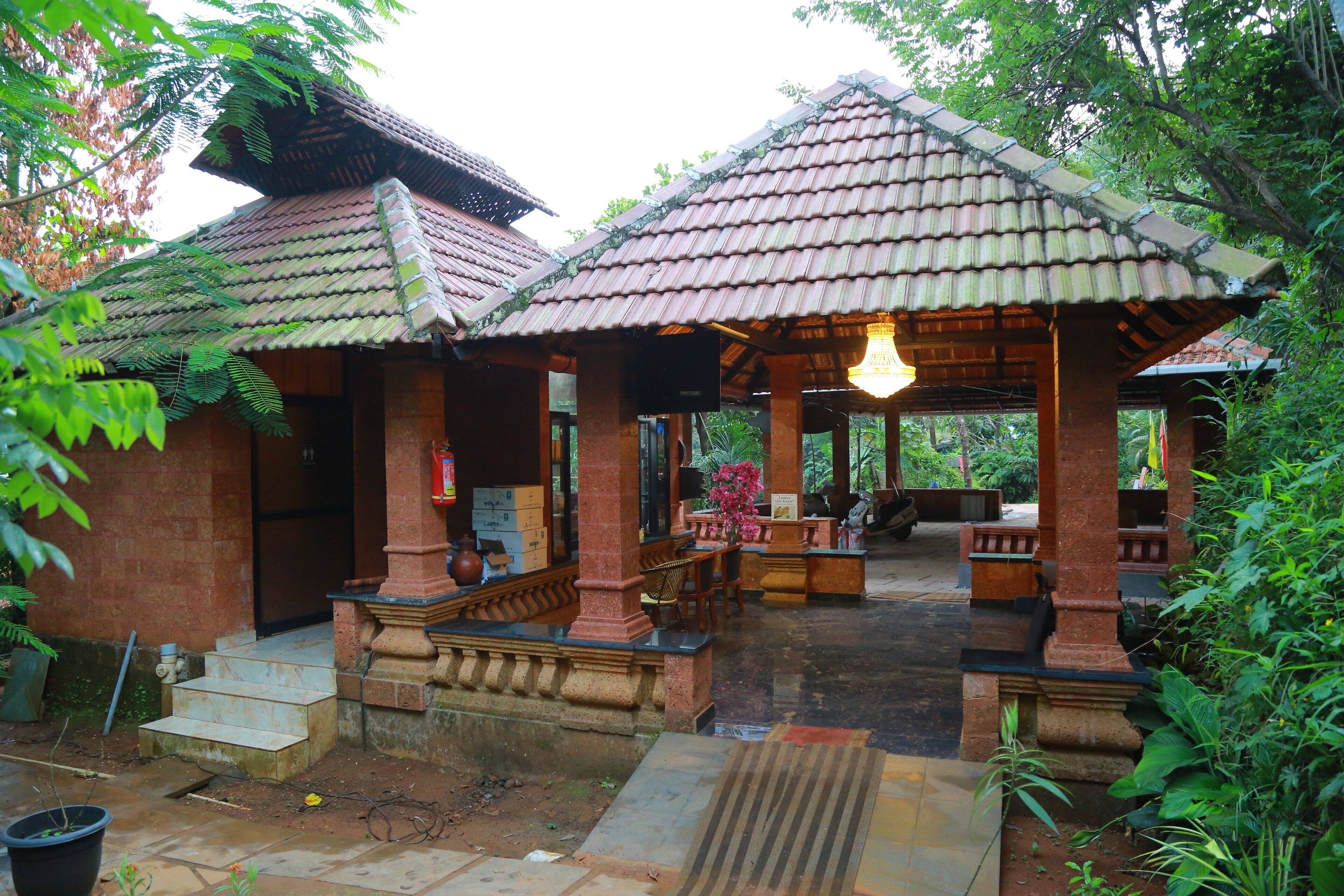 A traditional building with a tiled roof and a covered seating area.