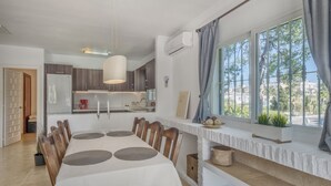 A modern kitchen with a dining area, large windows, and a view of the outside. - 3 bedroom with private garden walking distance to everything (Marbella)